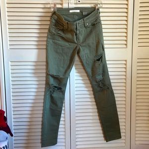 Green ripped skinny jeans. Low rise, ankle cut.